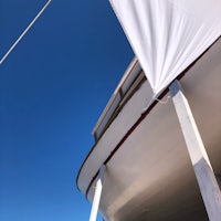 the deck of a boat with a white tarp on it